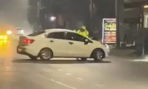 VIDEO: Tài xế ô tô tăng ga hất văng CSGT lên nắp capo bỏ chạy